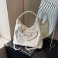 Large cream tote bag with elegant bow detail and plush cloud pendant on a dark desk - Off-white