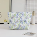 Detail of quilted floral makeup bag with blue flower pattern and large storage capacity - Large Capacity / Blue Flowers with Green Leaves