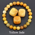 Detailed macro view of yellow jade beaded bracelet with natural raw stones in amber tones - Topaz