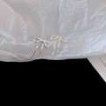 Close-up of elegant silver bow-shaped stud earrings with minimalist metal design - Silver Pin - Small Bow Stud Earrings