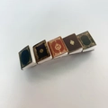 Detail of five miniature vintage book hair clips with gold patterns and colorful covers - 27# Western Style Book Clip