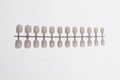 Detailed view of 24 short square nude press-on nails on a plastic runner set - Nude Gray (DFYL-05)