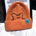Orange knitted beanie featuring cute bear embroidery and a blue woven label with smiley - One Size / Orange (With Bear Embroidery)