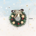 Close-up of a 6.5cm miniature Christmas wreath with gold bells and Merry Christmas ribbon - 11# Wreath [No Base Support]