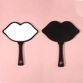 Lip-shaped handheld makeup mirror with black shell design on a soft pink background - 18*21.5 Large Black