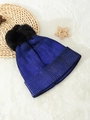 Close-up of metallic blue knit beanie with black pompom on a soft white background - One Size / Sapphire Blue