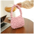 Close-up of pink chunky knit handbag featuring soft thick woven texture and handle - Pink