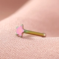 Macro shot of rainbow stainless steel star-shaped nose stud with polished finish - Colorful