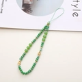 Detail of green crystal beaded phone lanyard with gold floral charms and wrist strap - Green