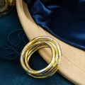 Close-up of stacked gold and silver textured wrap bracelets on a blue silk fabric - Gold & Silver Mixed Closed Style