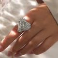 Macro detail of a sparkling heart-shaped ring with pavé crystals on a model's hand - Adjustable Open / Silver Heart Style (6010S)