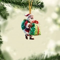 Close-up of a 3D cartoon Santa Claus acrylic ornament hanging on a green Christmas tree - Carrying Green Gift Bag Style (7)