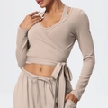 Close-up of brushed fabric yoga top with elegant cross-wrap tie detail at the waist - S / Tops / Flaxen