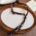 Close-up of brown floral fabric necklace with white baroque patterns and a red bead detail - Style 21-Coffee
