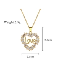 Detail view of a gold heart pendant with Love lettering and dimensions 2.6cm by 2.1cm - Gold Heart LOVE Micro-set Pendant