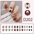 Short square press-on nails with brown heart and white bow patterns, model D202 - Chocolate Brown Cow Print Bow (D202)