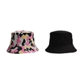 Flat lay of pink camouflage and solid black cotton bucket hats with stitching details - Pink & White Camo