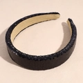 Close-up of black sequin headband featuring soft beige lining and sparkling texture - Black