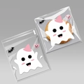 Close-up of Halloween treat bags with white ghost patterns and pink hearts for party cookies - White Ghost Design Approx 100pcs