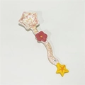 Pink ceramic spoon with star-shaped ends and flower detail on a wavy handle - Star - Red Flower