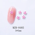 Macro shot of 5mm pink mini 5-petal flower nail charms with silver beads and edging - Pink Flower (8485)