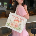White canvas tote bag featuring pink bird illustration and Chubby Bird lettering - Flower Bird