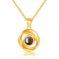 Golden swirl projection necklace with a black bead pendant and a thin chain - Rotating Circle Gold
