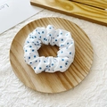 White scrunchie with royal blue polka dots on a wooden tray for elegant hair styling - Blue Polka Dots on White