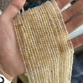 Faceted light yellow natural quartz tiny beads for jewelry making displayed in hand - Citrine 3mm