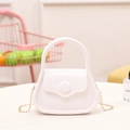 White mini silicone jelly bag with top handle, gold chain strap, and round buckle decoration - White