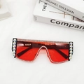 Close-up of oversized oversized red lens sunglasses with sparkling diamond rhinestone frame - Black Frame Red Lens