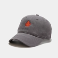 Detailed view of maple leaf embroidery on dark grey cotton baseball cap with ventilation holes - Adjustable / Gray
