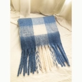 Macro shot of blue and white checkered scarf with soft wool texture and tassel detail - Blue & White