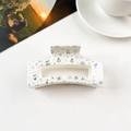 Close-up of white square hair claw clip with colorful laser star and snowflake patterns - 8.5cm Square - Creamy White Holographic Christmas
