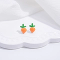 Detail of cute S925 silver carrot stud earrings on a wavy white display tray - Orange Carrot