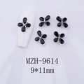 Detailed macro view of 9x11mm black floral nail art charm with zircon center on nails - Black Gem - Silver Base (MZH-9614)