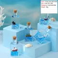 Miniature de voilier en bouteille avec liquide bleu pour décoration de bureau - Série Petit Bateau