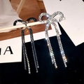Sparkling silver and blue rhinestone bow earrings with long tassels in two distinct finishes - Clip-on Earrings / Silver