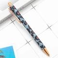 Leopard glitter ballpoint pen with rose gold trim on a white grid background - Blue Leopard