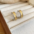 Close-up of C-shaped two-tone gold and silver earrings with hammered texture finish - Silver (Silver Earring Post)