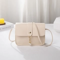 Chic beige crossbody square bag featuring elegant pearl charm and gold-tone stud detail - Off White
