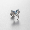 Silver bow stud earring with blue gems and titanium steel flat back screw on a grey surface - Blue Butterfly (Single)