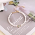 Elegant 18K gold-plated pearl bracelet with zircon heart opal pendant on floral background - Light Blue