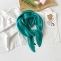 Elegant peacock green pleated satin silk scarf with a minimal woven label on white surface - 70*70cm / Pleated Apple Green