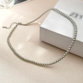 Silver-grey pearl necklace with metal lobster clasp on a textured white gift box - 4mm Grey