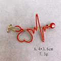 Spilla stetoscopio ECG dorata con smalto rosso e strass luccicanti, misura 6,4x3,6 cm - ECG Rosso