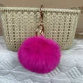 Faux rabbit fur ball keychain in rose pink with a polished gold metal clasp - Rose Red