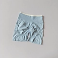 Detail showing high-waisted seamless light blue yoga shorts with scrunch butt lifting design - Baby Blue