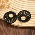 Chic black round hollow wooden earrings with geometric pattern on wooden tray - Black