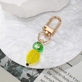 Miniature lemon glass pendant keychain with yellow translucent resin and gold lobster clasp - Banana